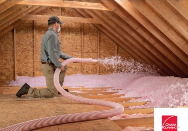 Technician blowing in attic insalivation. 