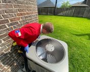 HVAC technician checking Ac fans