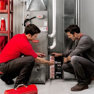Bryant technician servicing furnace