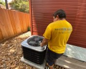 HVAC technician installing AC unit