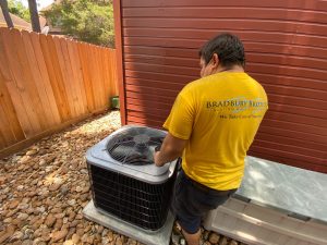 HVAC technician installing AC unit