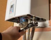 plumber working on a tankless hot water heater