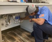 Plumber installing water filtration system